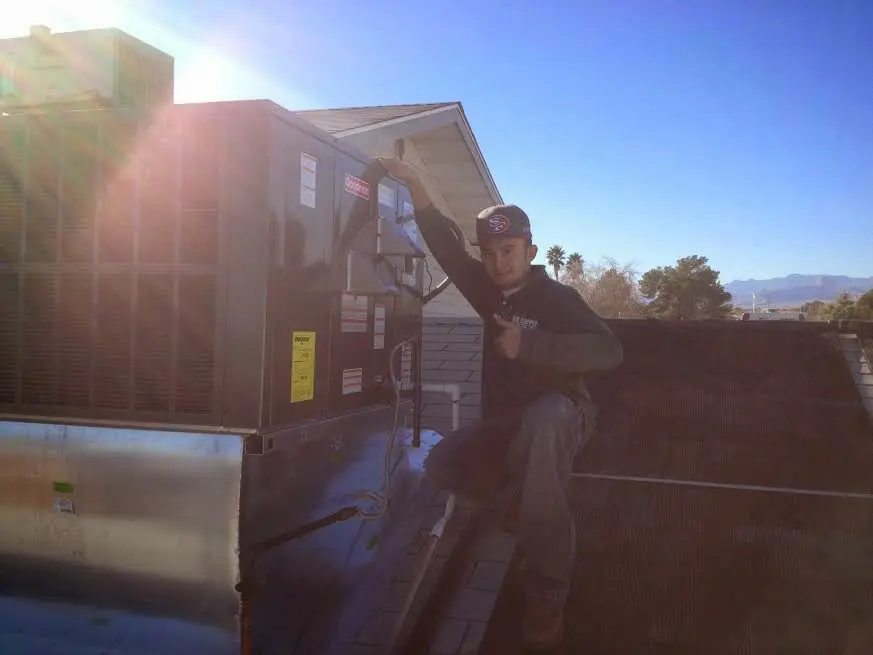 HVAC technician performing HVAC Inspection on a rooftop unit in East Liverpool